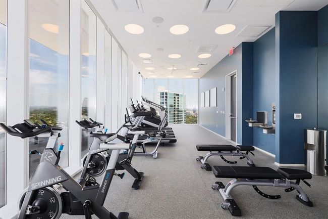 Gym featuring expansive windows, top of the line gym equipment and vies of West Austin/ Lady Bird Lake | Image 19