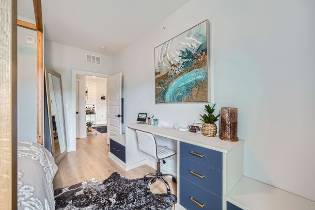 Home office with light wood-style flooring and baseboards | Image 12