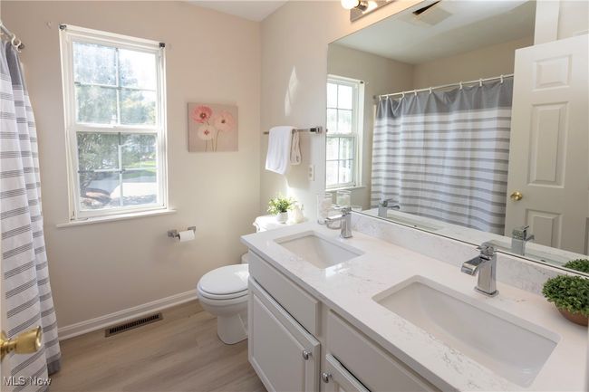 The 2nd full bath upstairs has updated quartz counters, undermount dual sinks and room to get ready! | Image 24