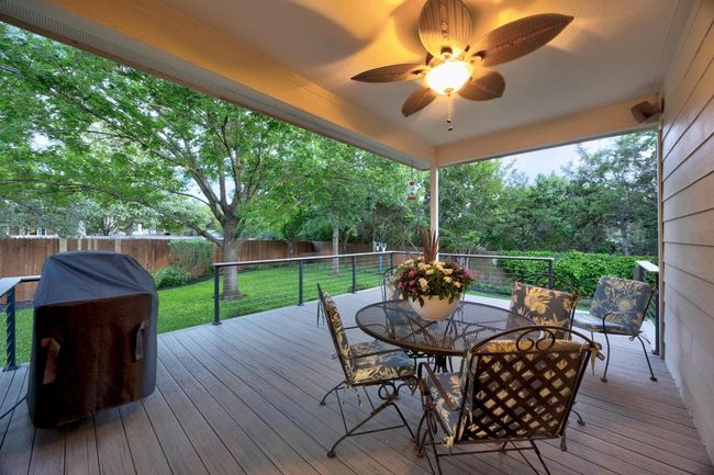 The home has an incredible backyard with privacy, mature landscaping, and plenty of green space. Enjoy from the covered patio. The current owners replaced and enlarged the deck and added railing. They used TimberTechPro-Legacy Driftwood. | Image 4