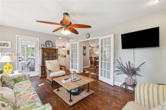 Second living room with plenty of lounging areas, gorgeous open windows allow for plenty of natural light if desired, hardwood floors. | Image 40