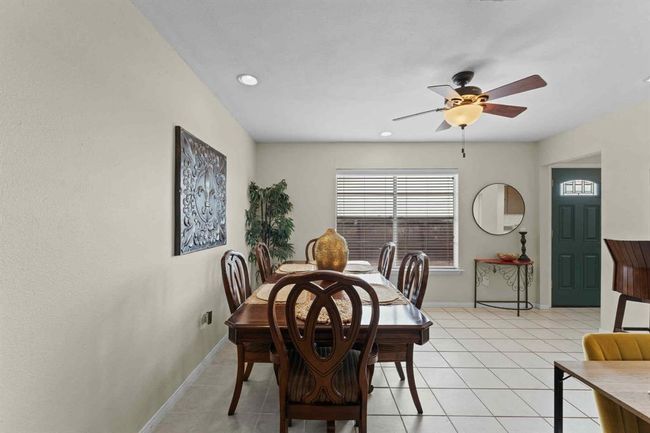 This comfy dining space opens right into the kitchen, making it the perfect setup for casual meals, conversation, and connection | Image 11
