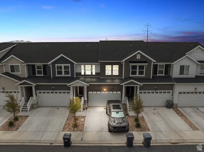 View of property with an attached garage, driveway, and board and batten siding | Image 33