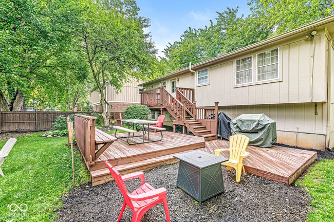 wooden deck with stairway, a grill, and a fire pit | Image 31