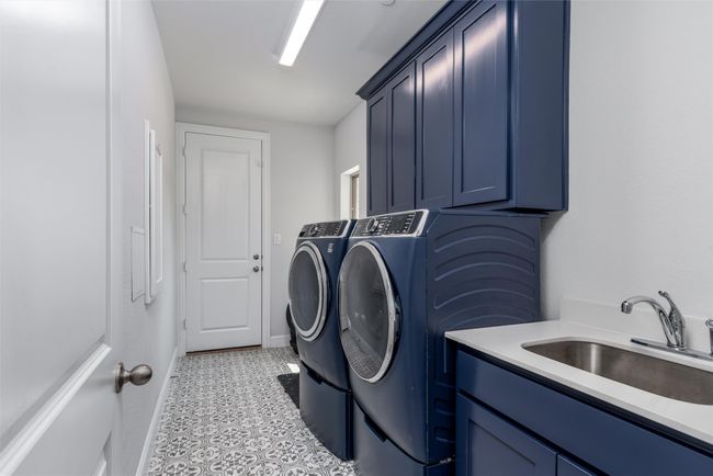 Laundry room featuring washer and dryer, cabinet space, and baseboards | Image 28