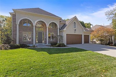 View of front of home featuring a front lawn and a garage | Image 2