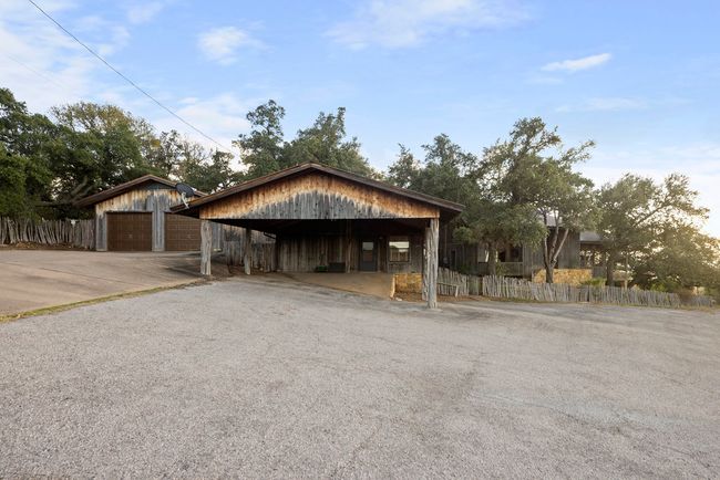 Garage featuring a carport and asphalt driveway | Image 27