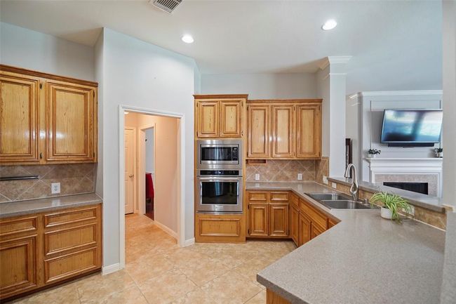 Stainless steel appliances with sweeping countertops. | Image 8