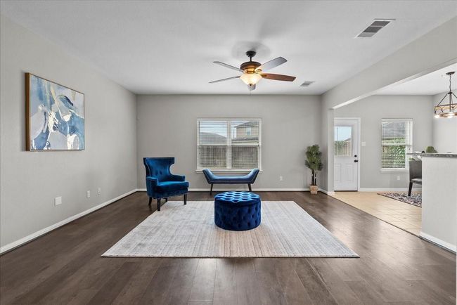 Continue walking in and enter a large and spacious living space that's perfect for gathering with family and friends! The open-concept floorplan was designed for connection and comfort, this space is ideal for making memories! | Image 5