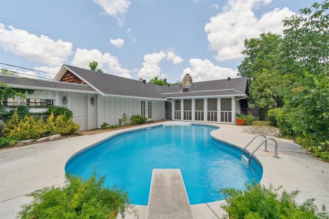 View of pool featuring french doors, a sunroom, a patio area, and a diving board | Image 39
