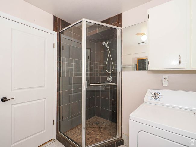 Bathroom with washer / clothes dryer and a shower stall | Image 27