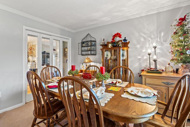 Carpeted dining space with french doors and ornamental molding | Image 12