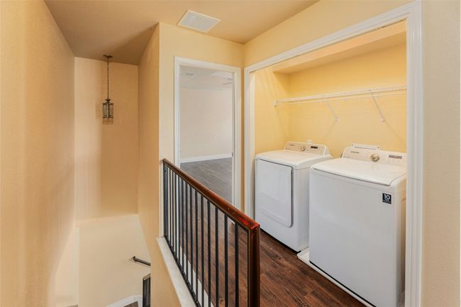 Washroom with washing machine and clothes dryer and dark wood finished floors | Image 24