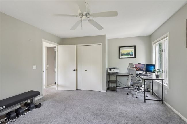 Carpeted home office with ceiling fan and baseboards | Image 23