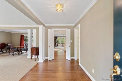 Foyer entrance featuring decorative columns, hardwood / wood-style flooring, and crown molding | Image 2