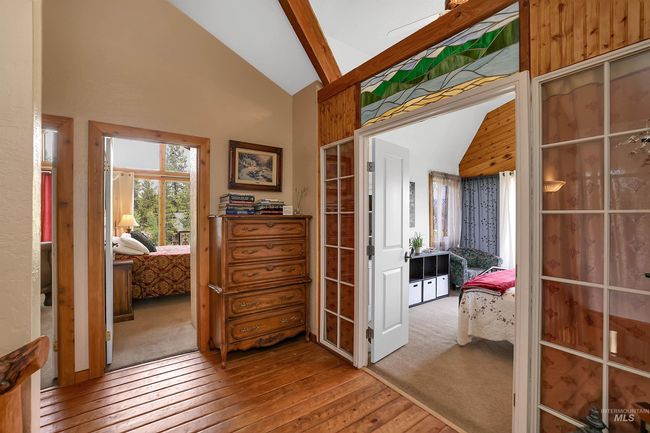 Hallway featuring hardwood / wood-style flooring, high vaulted ceiling, and beamed ceiling | Image 21