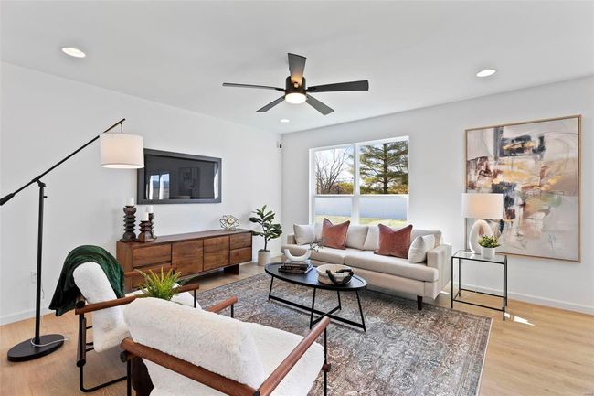 Living room featuring ceiling fan and light hardwood / wood-style flooring | Image 5