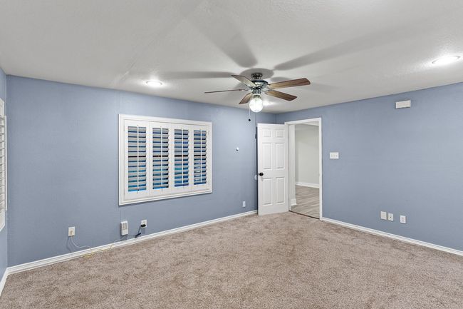 Unfurnished bedroom featuring carpet, baseboards, and ceiling fan | Image 25