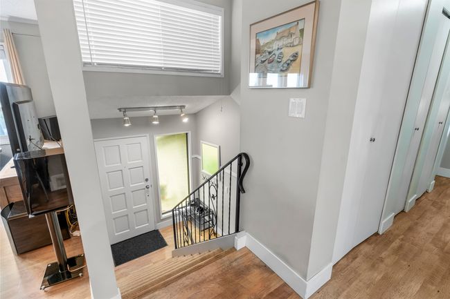 Entryway with rail lighting, baseboards, and wood finished floors | Image 20