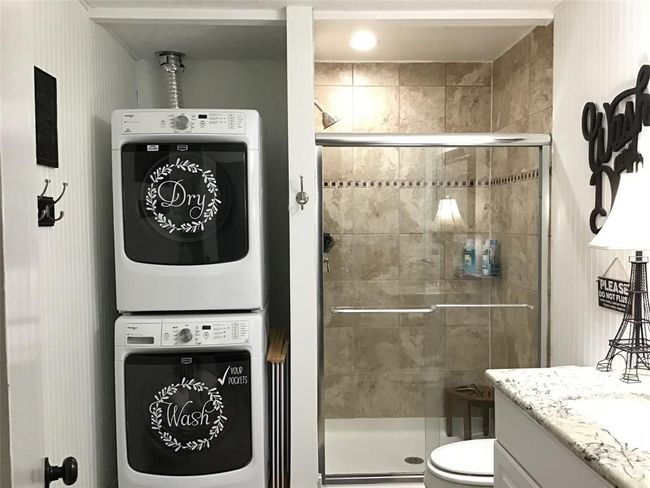 Stackable laundry, large walk-in shower and single sink vanity. | Image 31