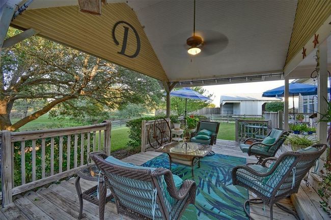 1500sf of decking with ~ 400sf under cover off the rear of the home with a sweeping view of the trees, pasture and the pool | Image 19