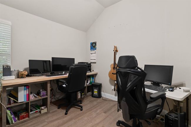 Bedroom or office area featuring vaulted ceiling and wood finished floors | Image 16