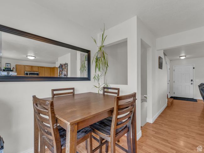 Dining area with baseboards and light wood-style floors | Image 15