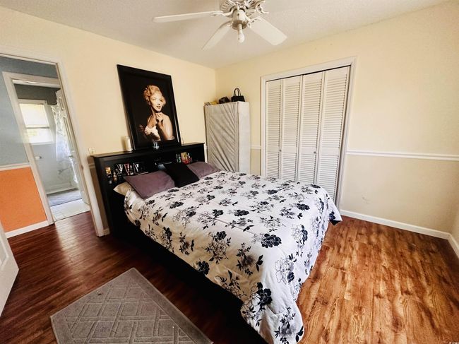 Bedroom featuring ceiling fan, a closet, baseboards, and wood finished floors | Image 14