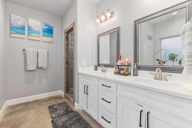 Bathroom featuring vanity, an enclosed shower, and concrete floors | Image 18