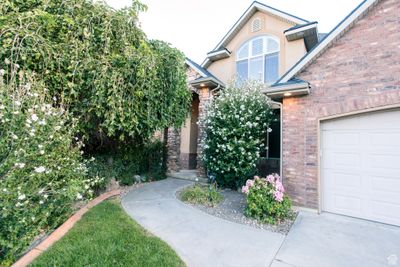 View of exterior entry with a garage | Image 2