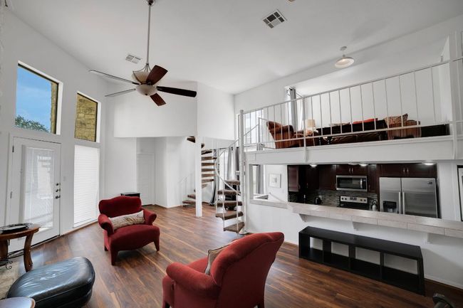 Living room featuring two-story ceiling | Image 5