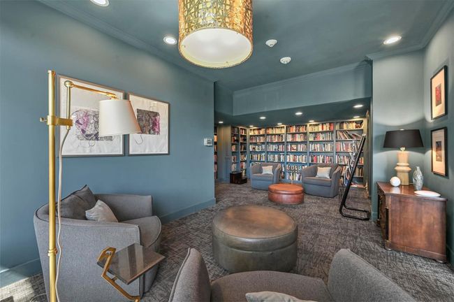 Sitting room featuring crown molding, carpet floors, recessed lighting, and wall of books | Image 12