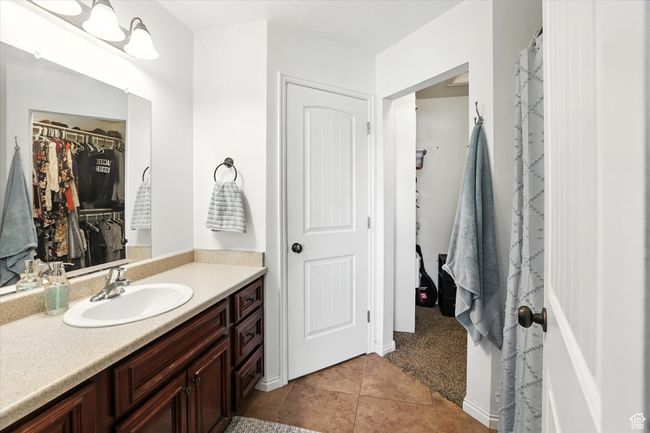 Bathroom featuring vanity, tile patterned flooring, and a walk in closet | Image 20