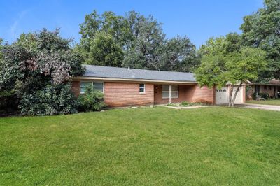 Ranch-style home with a garage and a front yard | Image 2