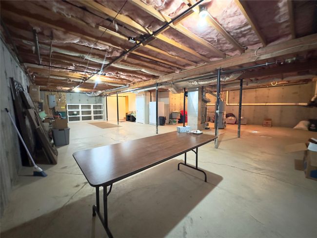 Unfinished below grade area with freestanding refrigerator | Image 16