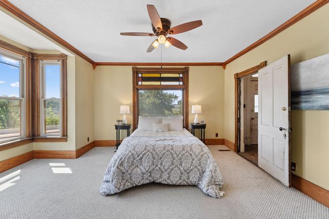 Main level primary bedroom with view of the Mississippi River | Image 7