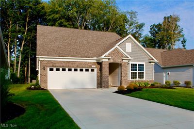 View of front facade with a garage and a front yard | Image 2