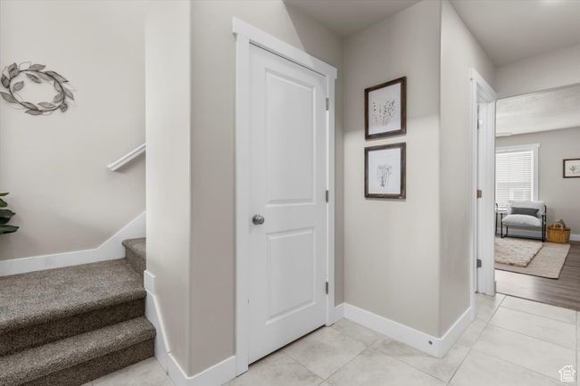 Staircase with baseboards and tile patterned flooring | Image 9