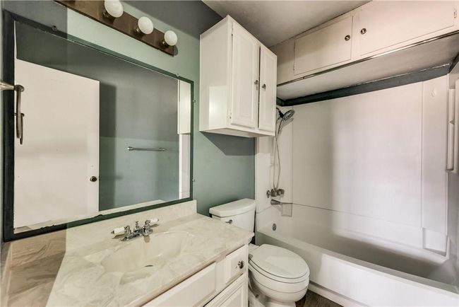 Bathroom featuring vanity and bathtub / shower combination | Image 12