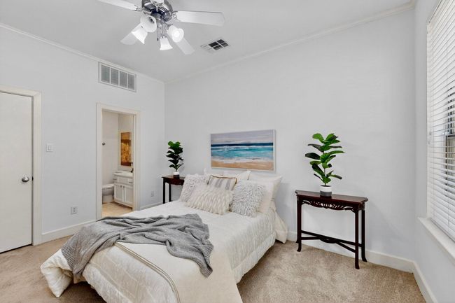 Bedroom with ornamental molding, carpet, connected bathroom, and ceiling fan | Image 30