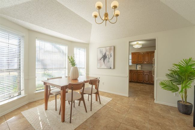 Dining area featuring tile flooring and chandelier | Image 15