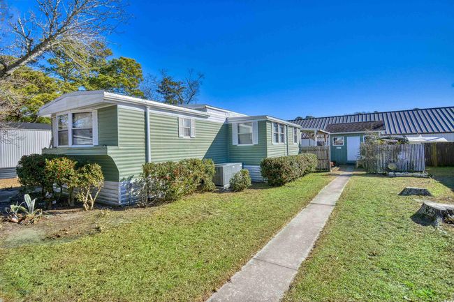 View of front of property featuring central air condition unit and a front yard | Image 16