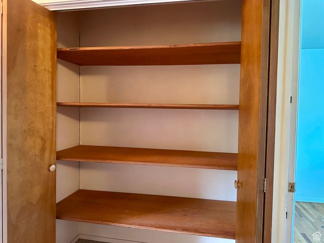 View of closet with built in shelves | Image 26