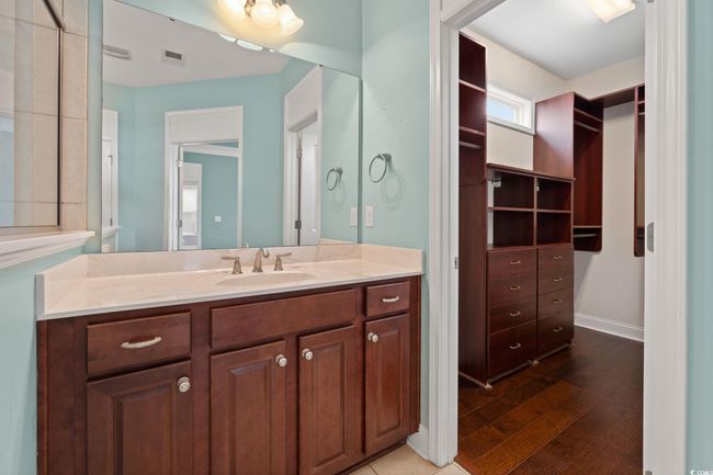 Bathroom with vanity, visible vents, and wood finished floors | Image 23