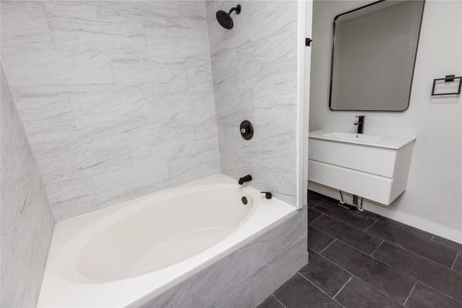 Full bath with vanity, shower combination, and baseboards | Image 28