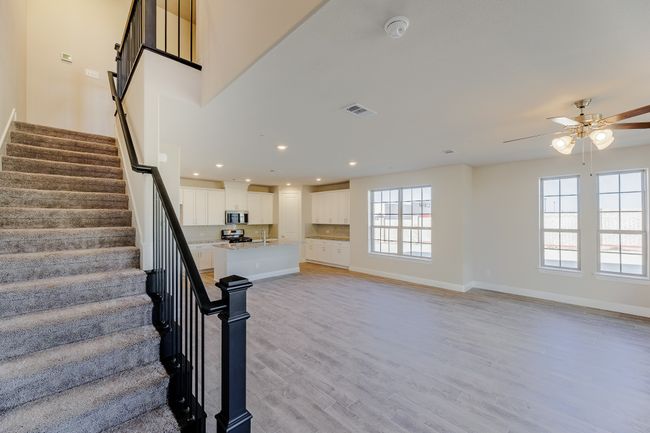 Staircase with a ceiling fan, wood finished floors, and recessed lighting | Image 6