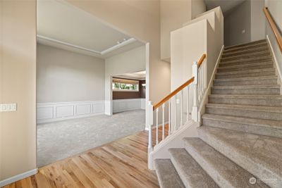 A sweeping grand staircase greets you, setting the tone for the luxury that lies ahead! | Image 3