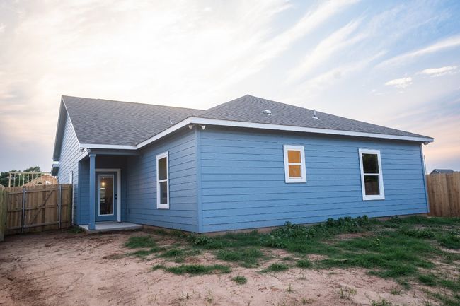 View of home's exterior with roof with shingles | Image 23