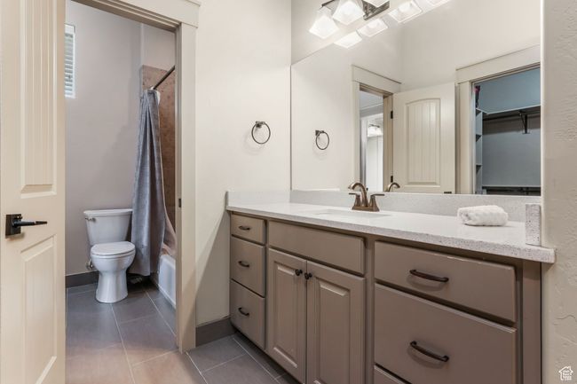Connected Bath bath featuring vanity, toilet, tile patterned flooring, and baseboards | Image 21
