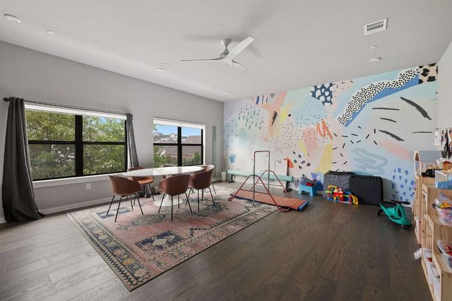 Game room featuring visible vents, ceiling fan, baseboards, and wood finished floors | Image 27